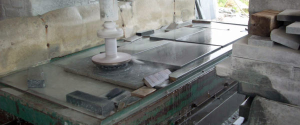 A machine polishes slab of soapstone